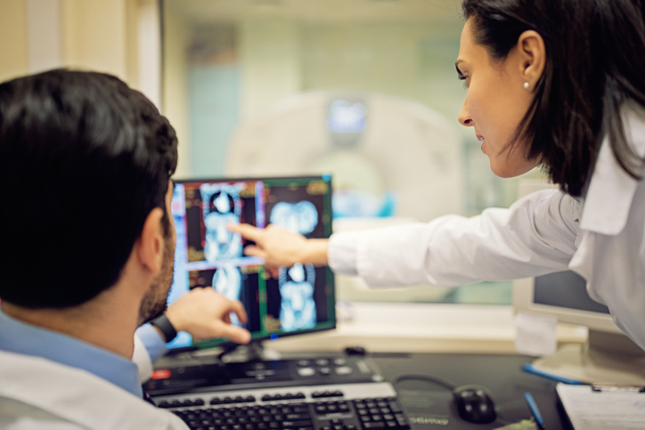 Photo shows doctors reviewing a CT scan