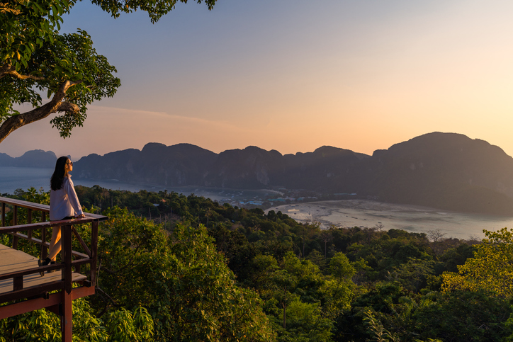 Photo shows a woman standing at Phi Phi View Point in Thailand