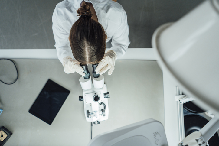 Photo shows Young scientist working with microscope in laboratory/Getty Inages