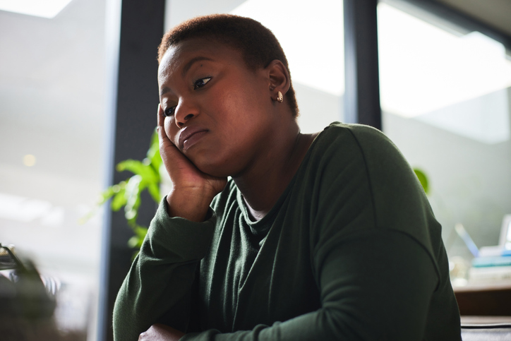 Photo shows a woman experiencing brain fog at work/Getty Images
