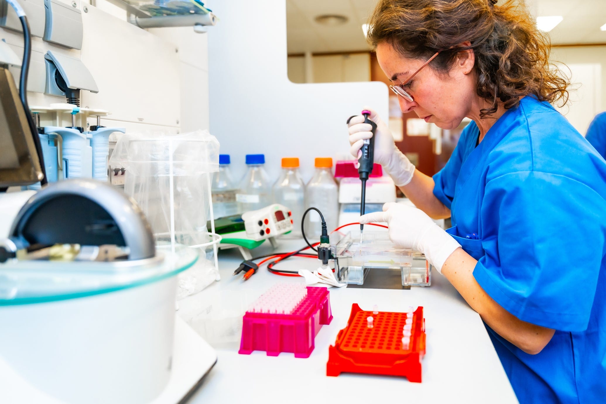 Research scientist working with a pipette in a lab