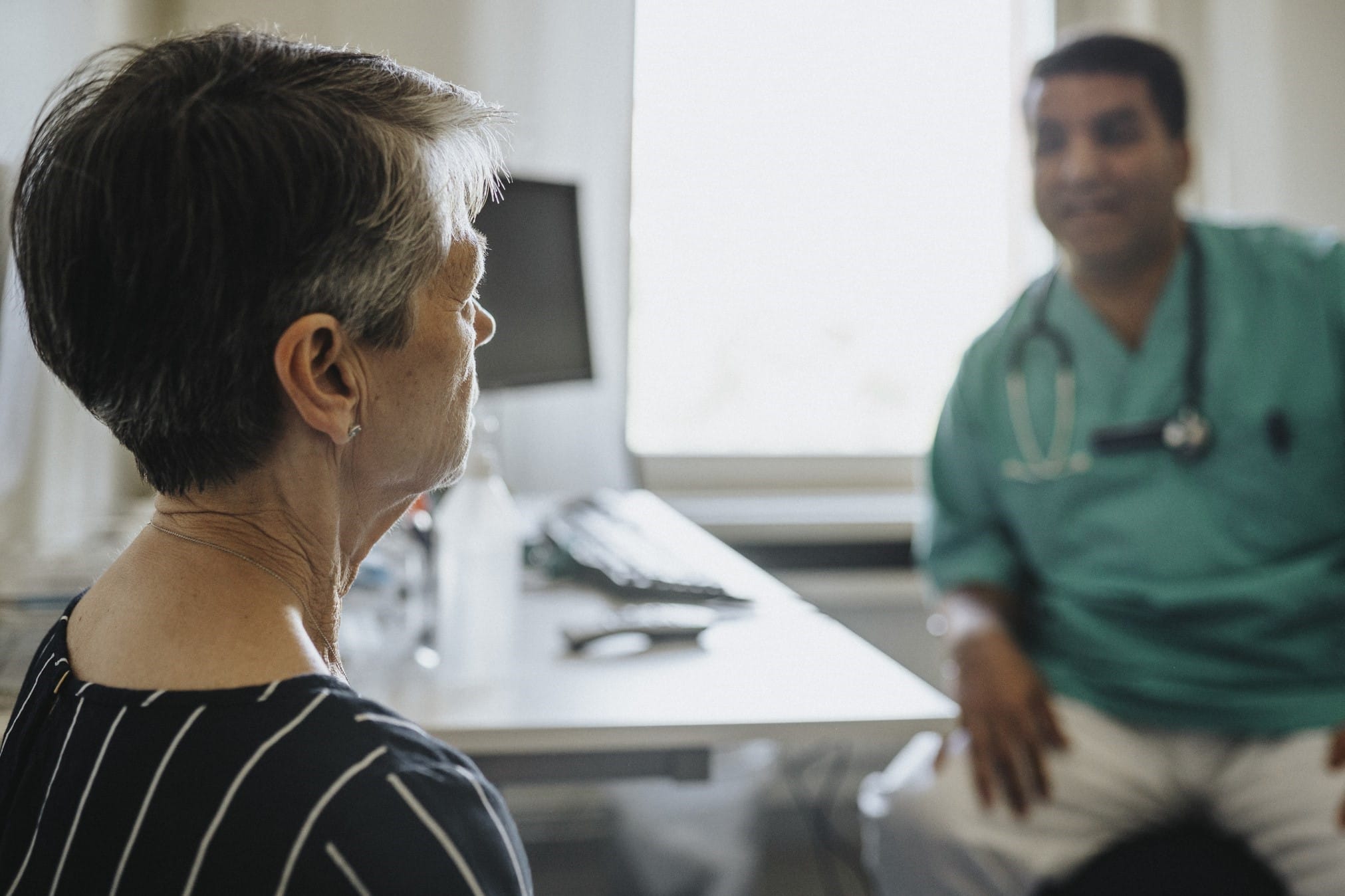 Middle-aged woman speaking with her doctor