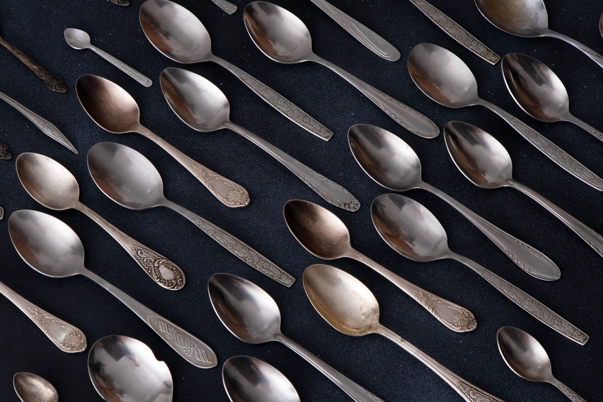 Old spoons against a dark background